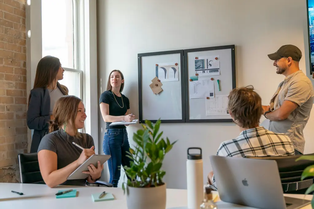 Colleagues meeting around a table in a bright office